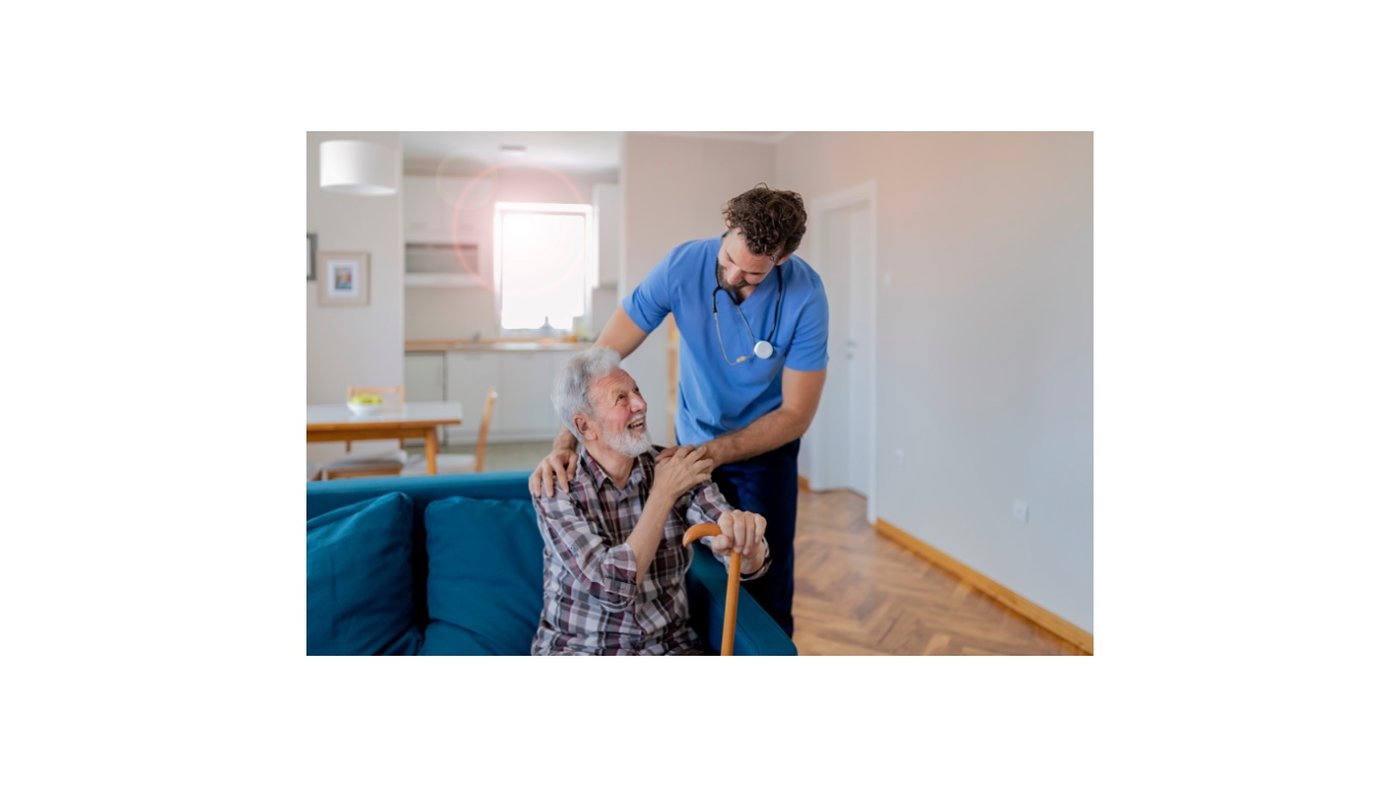 Male caregiver supporting elderly male client at home